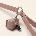 Close-up of the blush pink apple leather poo bag holder attached to the lead